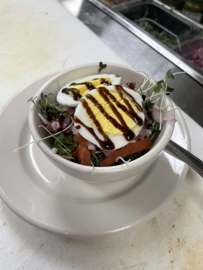 Salad bowl with soft-boiled egg and microgreens